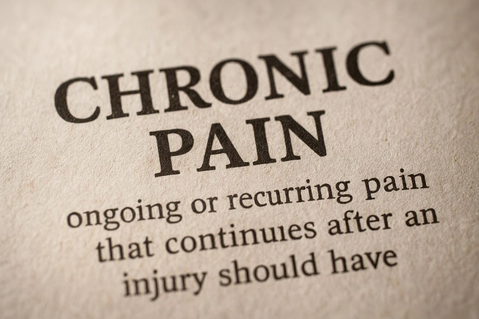 Close-up of a printed page showing the bold heading “CHRONIC PAIN” and smaller definition text